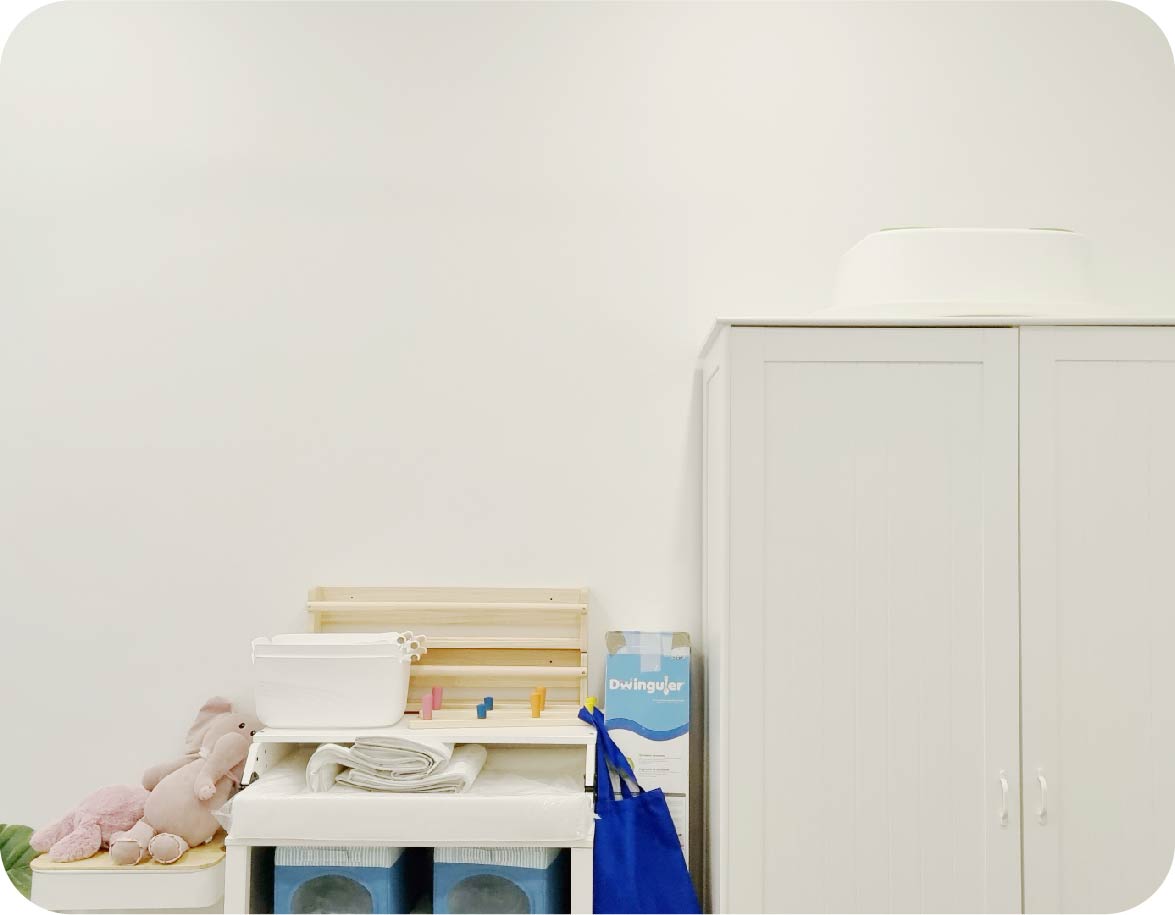 a kids room with a bland wall